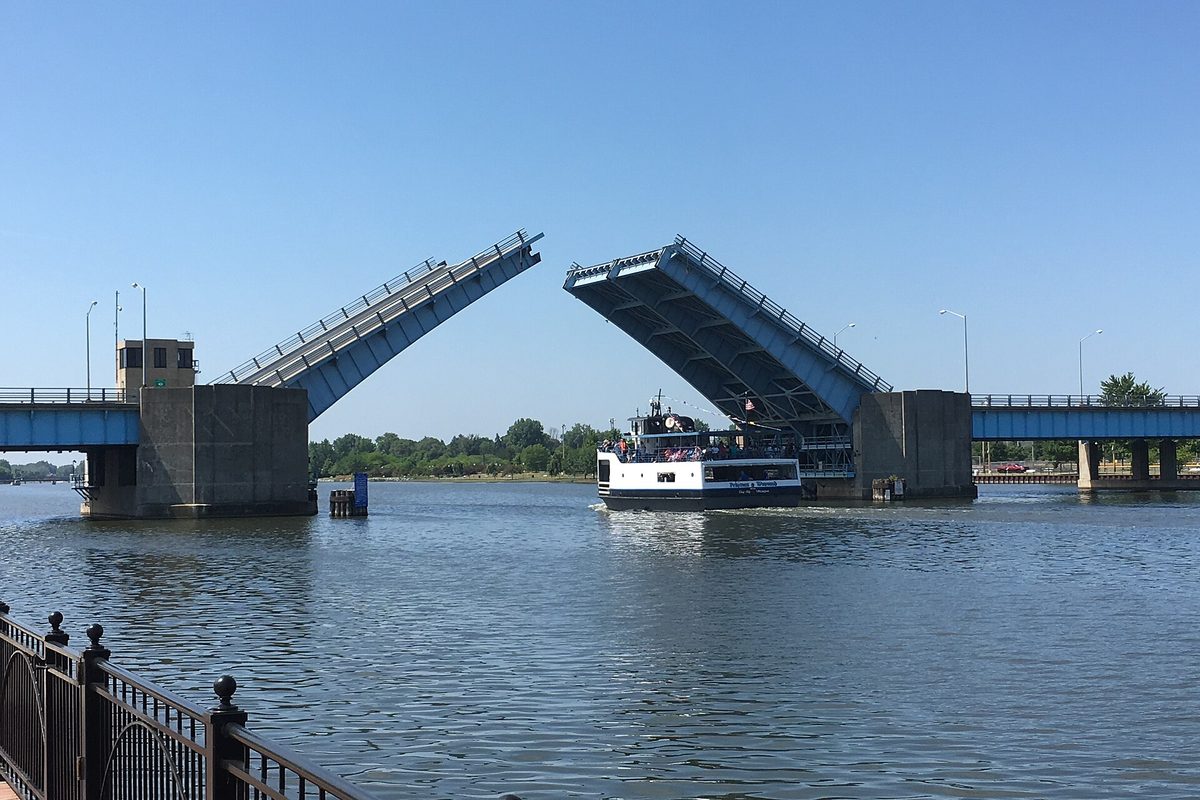 The Veterans Memorial Bridge in Bay City with both halves raised as the Princess Wenonah tour boat passes beneath on the river