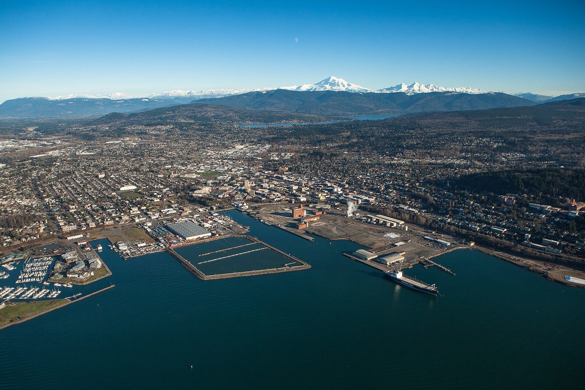 Aerial view of Bellingham's waterfront, downtown and marinas on Bellingham Bay, with snow-capped Mount Baker in the distance