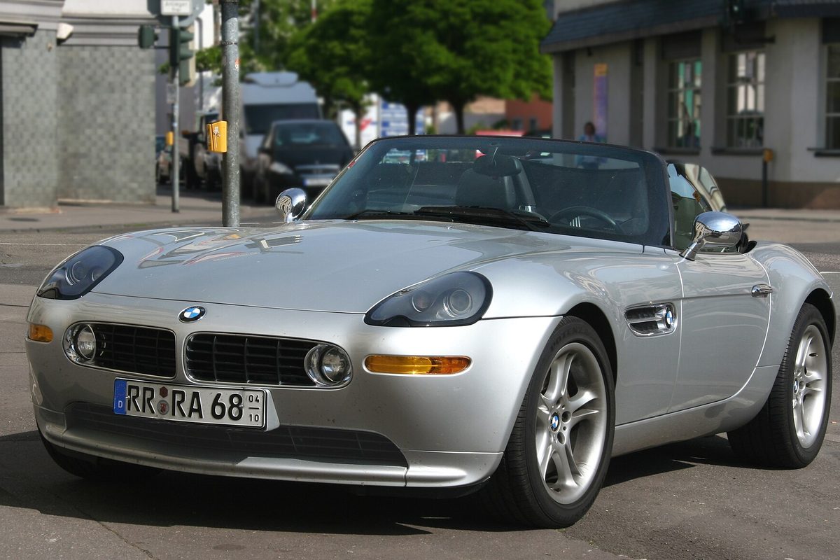 A silver BMW Z8 roadster with the top down on a city street