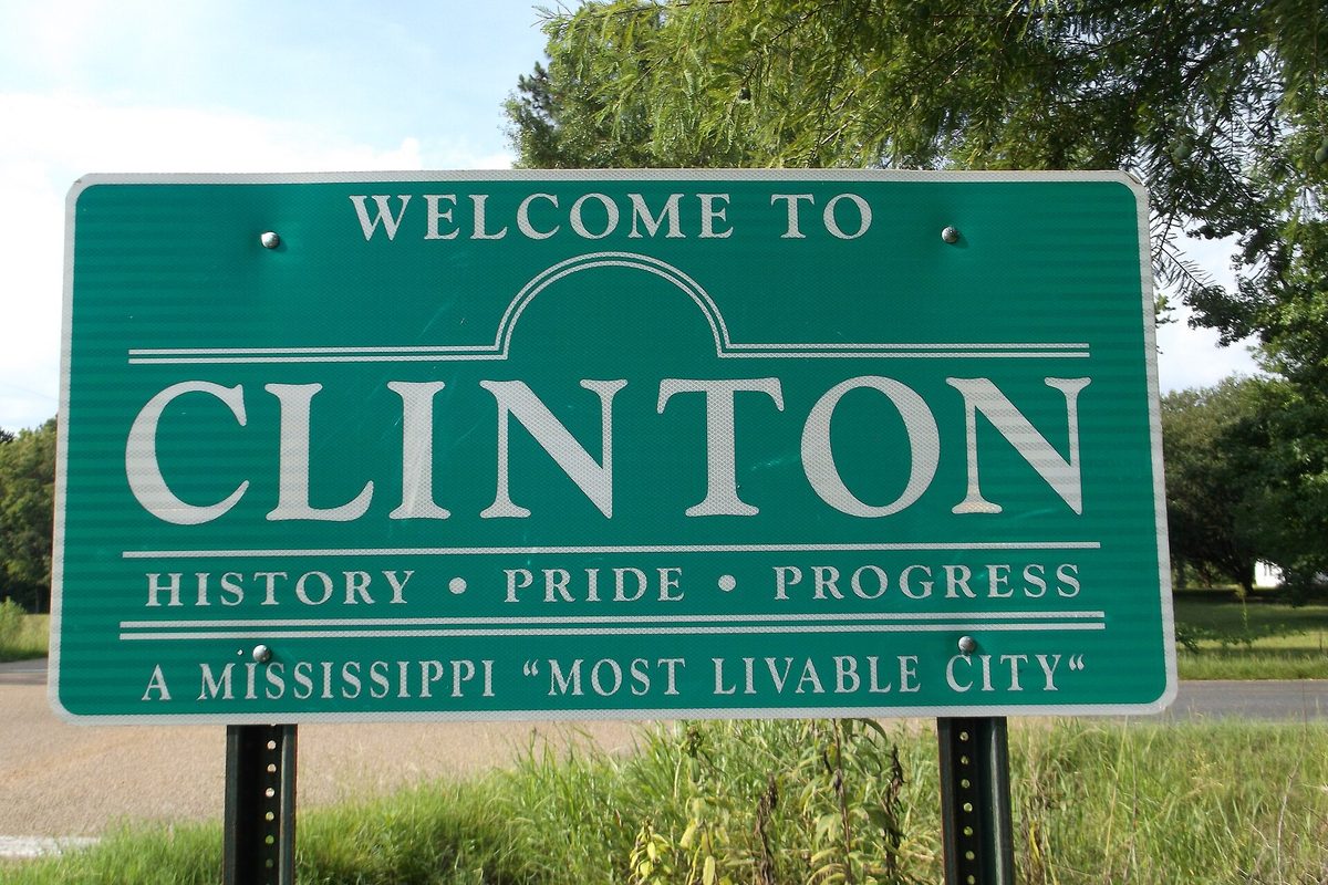 Green Welcome to Clinton road sign reading History, Pride, Progress and A Mississippi Most Livable City