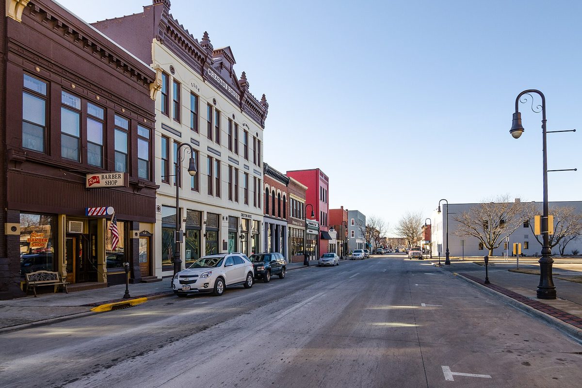 Brick and stone storefronts in Council Bluffs' Haymarket Historic District, a barber shop on the corner and ornate street lamps