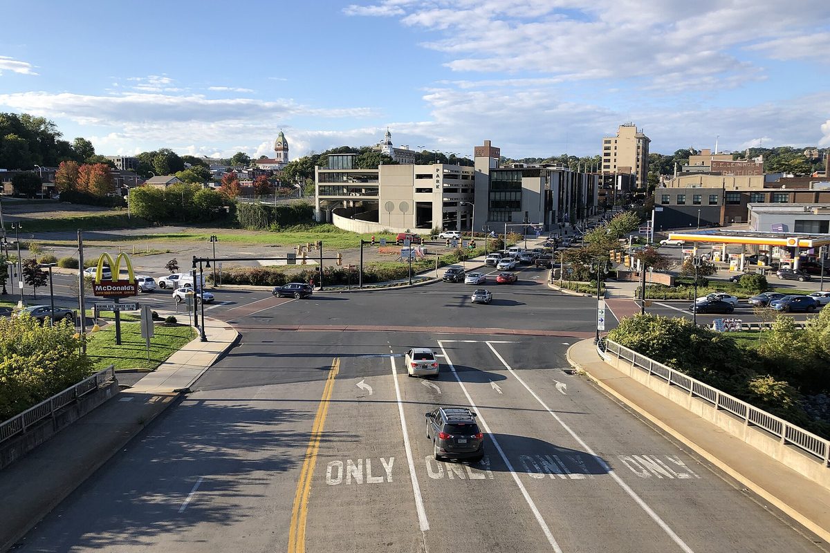 Looking north up Third Street in Easton from a rail overpass, with turn lanes painted ONLY, a parking garage, and a cupola tower on the skyline