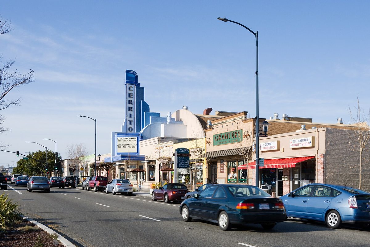 San Pablo Avenue in El Cerrito, with cars passing the blue tower sign of the historic Cerrito Theater