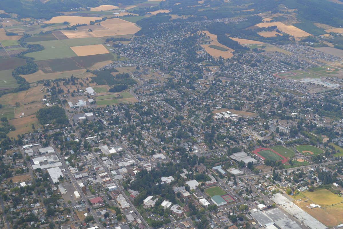 Aerial view of Forest Grove's street grid, sports fields and neighborhoods, ringed by farm fields