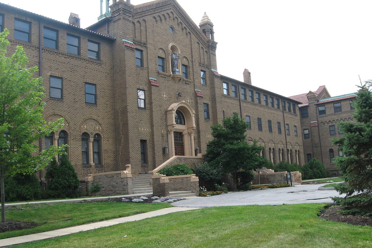 Marymount Congregational Home in Garfield Heights, a large tan-brick building with an arched entrance, a statue in a niche above the door and a lawn in front