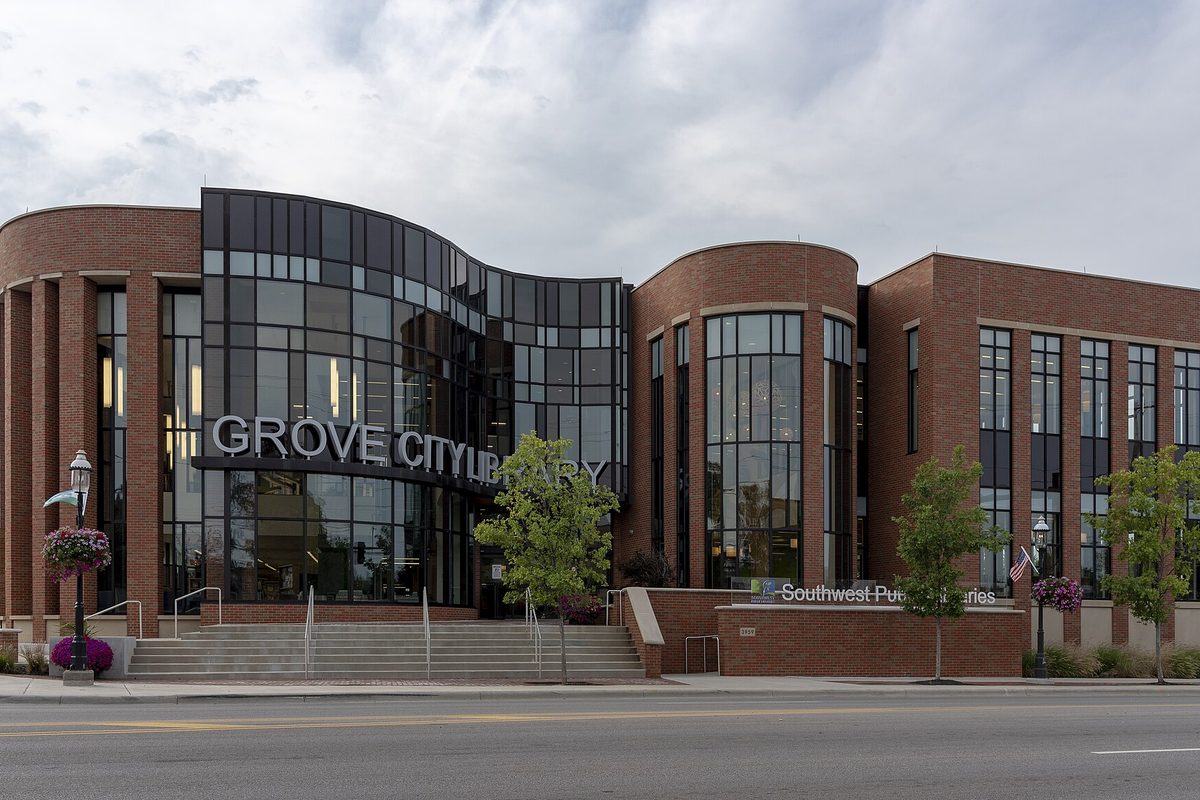 The brick and glass Grove City Library on Broadway, Grove City's main street, under a cloudy sky