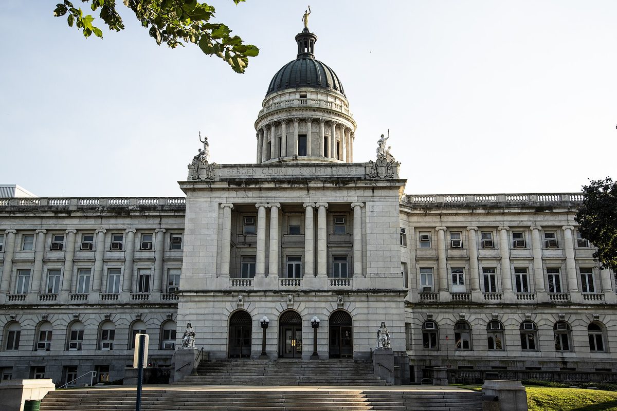 The domed white stone Bergen County Courthouse in Hackensack, with statues above its columned entrance and a wide flight of steps