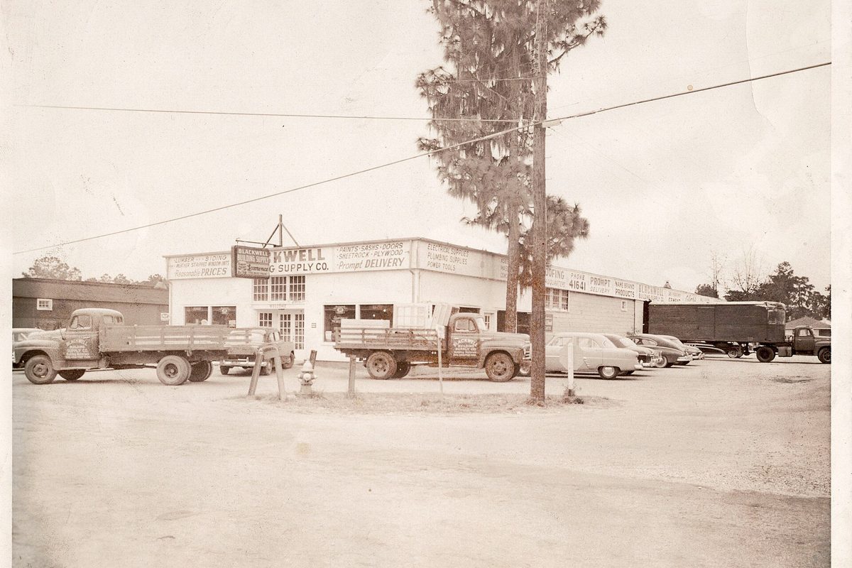 A 1947 photo of a hardware and supply store on Yeaman's Hall Road in Hanahan, with old flatbed trucks and cars parked out front