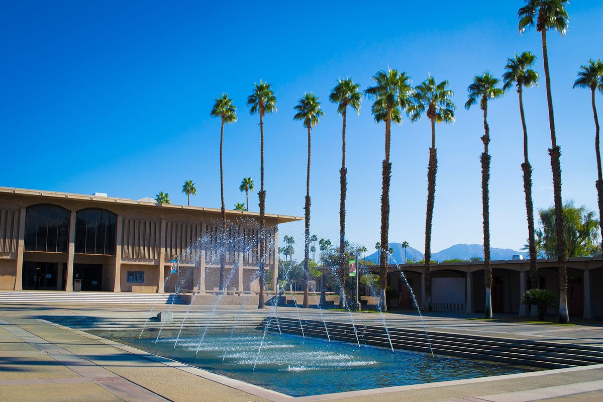 Water jets in the International Fountain of Knowledge on the College of the Desert campus in nearby Palm Desert, with tall palms and mountains behind