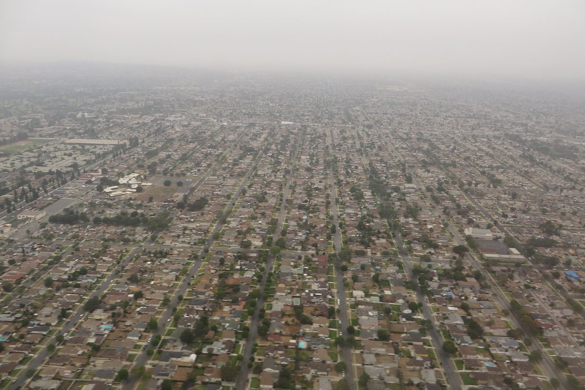 Hazy aerial view over Inglewood's dense grid of streets and low houses stretching toward the horizon