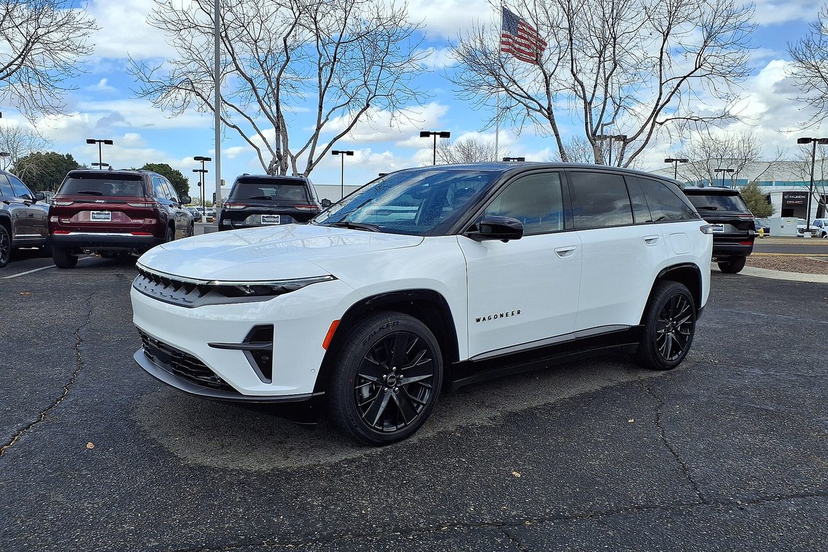 A white 2024 Jeep Wagoneer S Launch Edition with black wheels in a dealer parking lot
