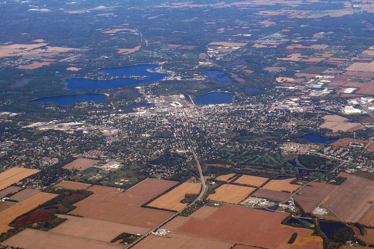 Aerial view of La Porte with a chain of lakes along the north side of town, its street grid in the middle and farm fields to the south