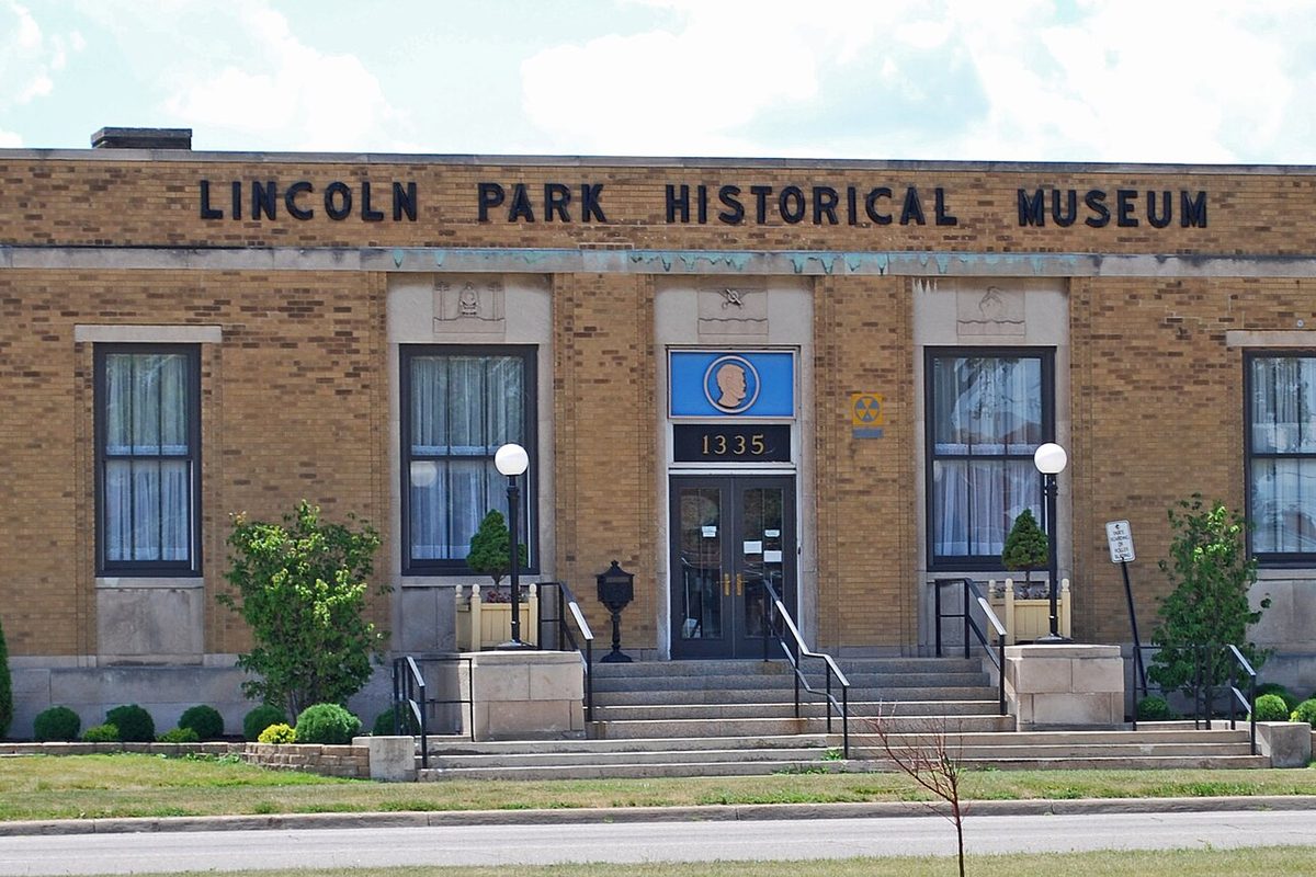 The buff brick Lincoln Park Historical Museum, a former post office, with its name across the top and the number 1335 above the double doors