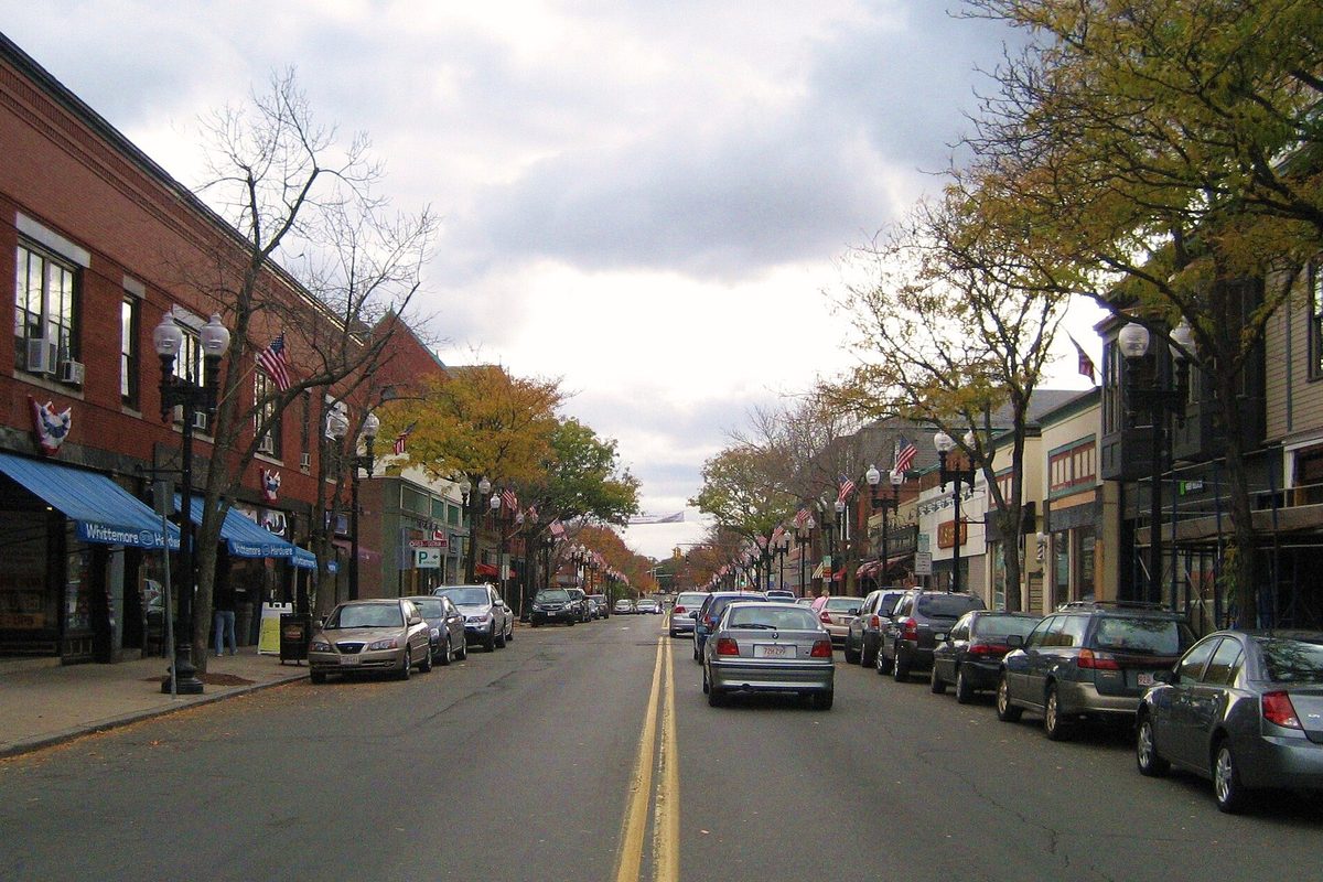 Downtown Melrose looking south along Main Street, with brick storefronts, autumn trees and cars parked on both sides