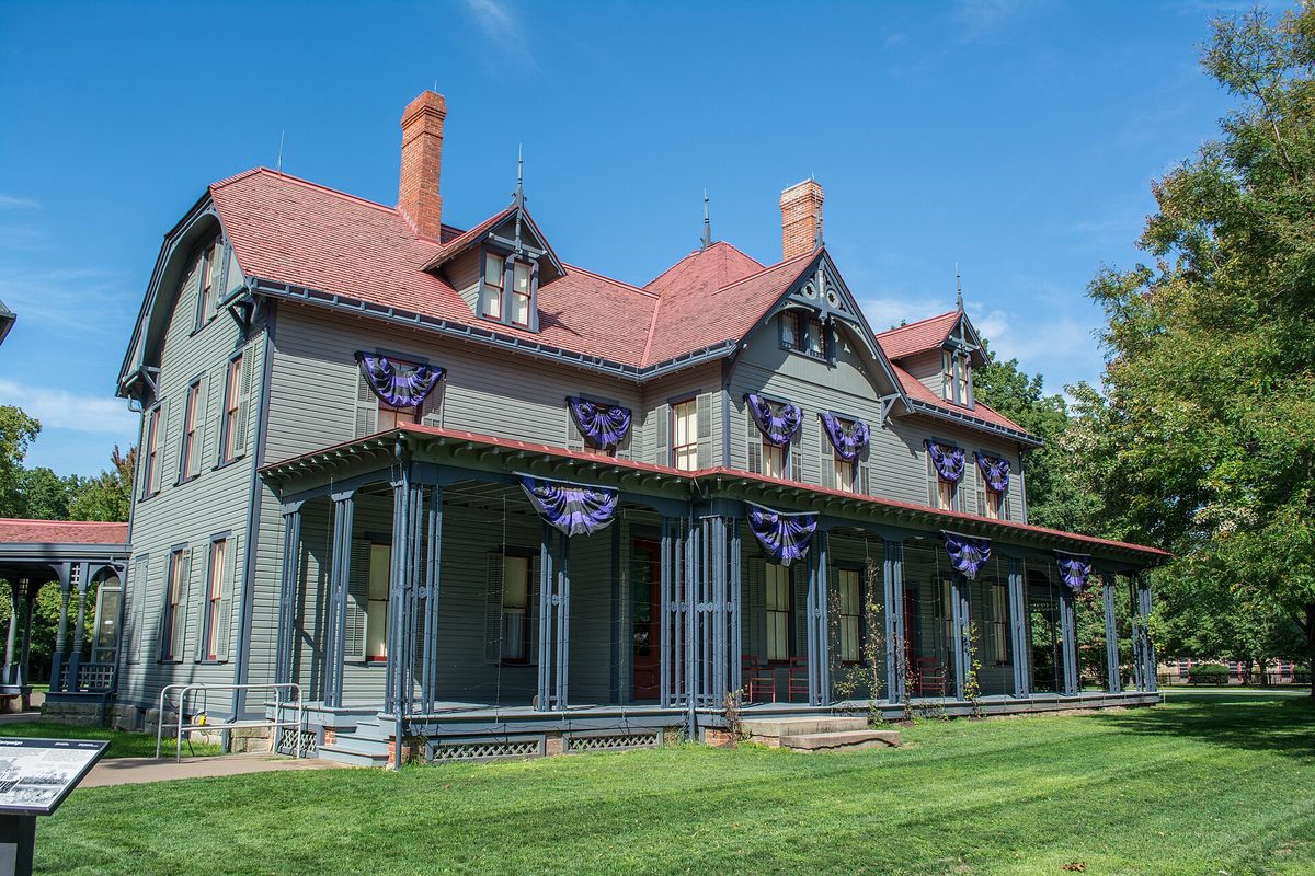 James A. Garfield's home at the national historic site in Mentor, a gray Victorian house with a red roof and a wide porch hung with dark purple bunting