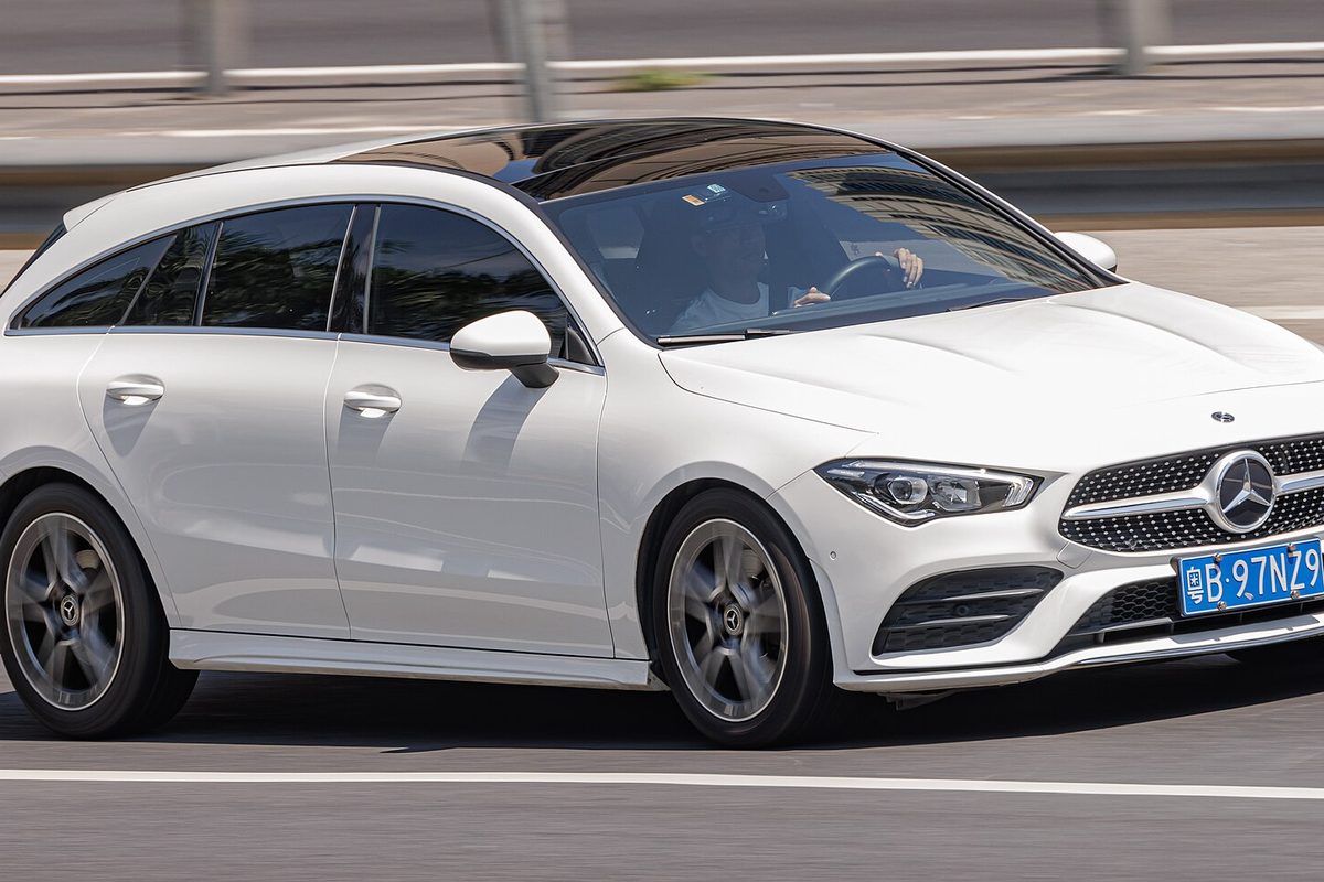 A white Mercedes-Benz CLA Shooting Brake wagon driving on a highway
