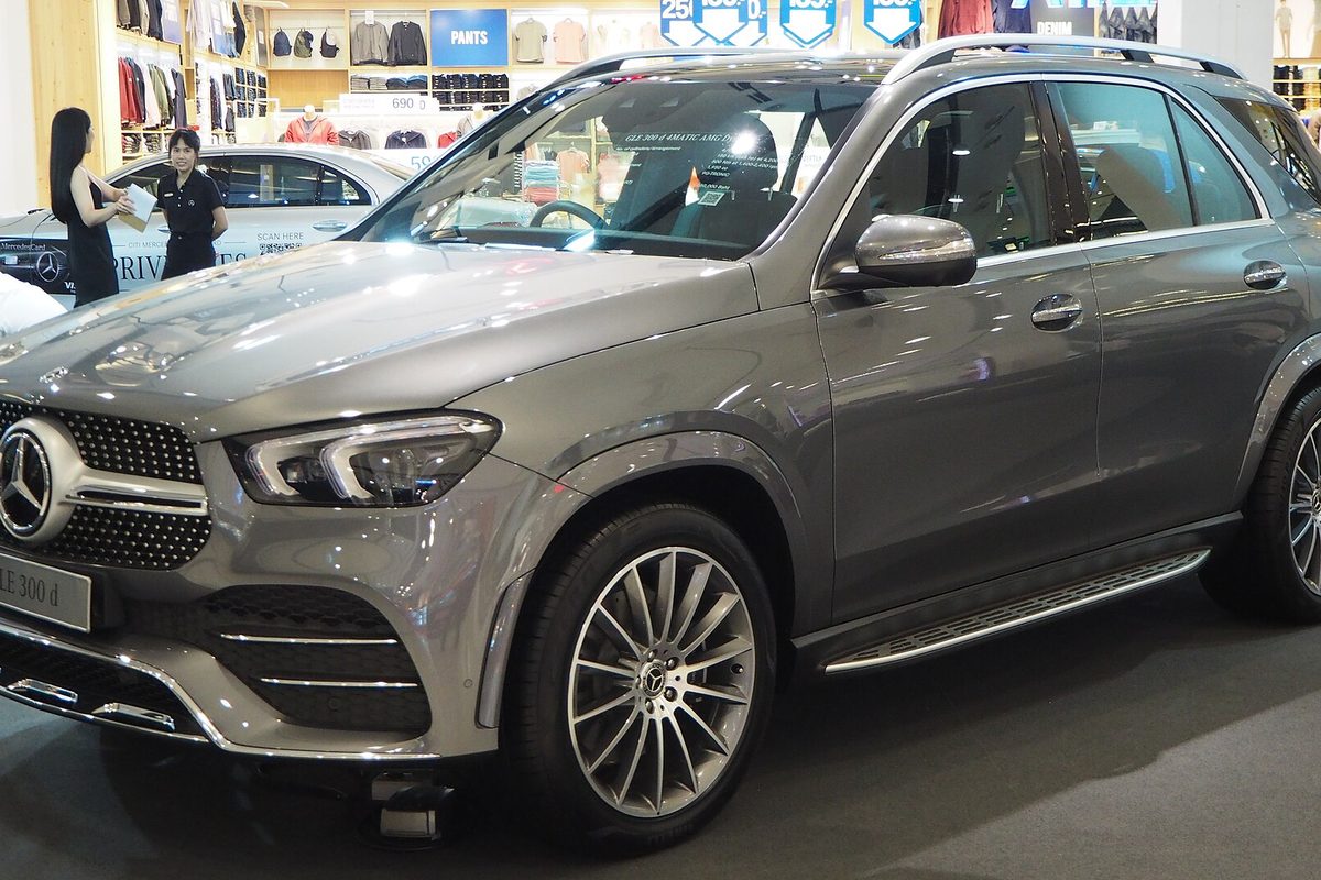 A gray Mercedes-Benz GLE SUV with multi-spoke wheels on display inside a shopping mall