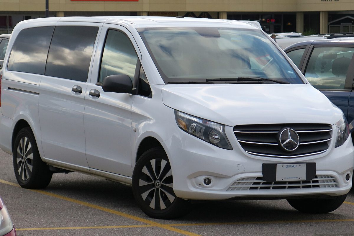 A white 2022 Mercedes-Benz Metris passenger van parked in a shopping center lot