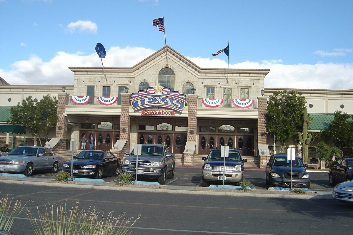 The front entrance of the Texas Station hotel-casino in North Las Vegas, with flags, red-white-and-blue bunting and cars parked out front