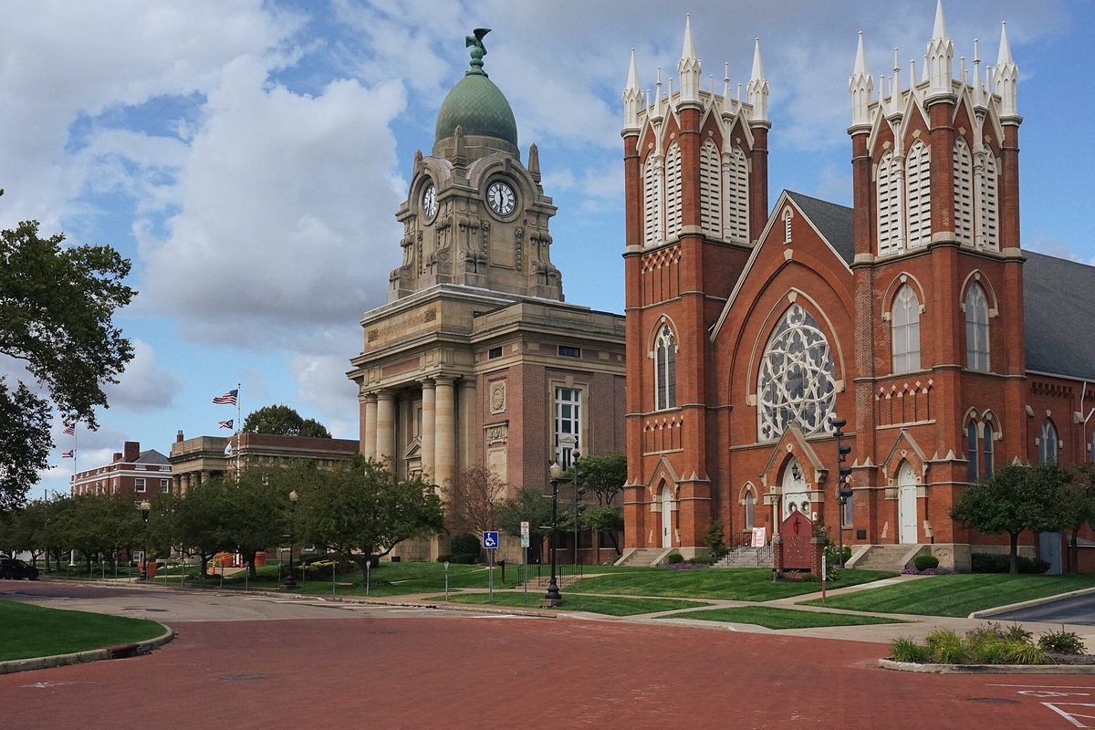 The domed Lake County Courthouse with its clock tower beside the red brick Gothic Methodist Episcopal Church on North Park Place in downtown Painesville