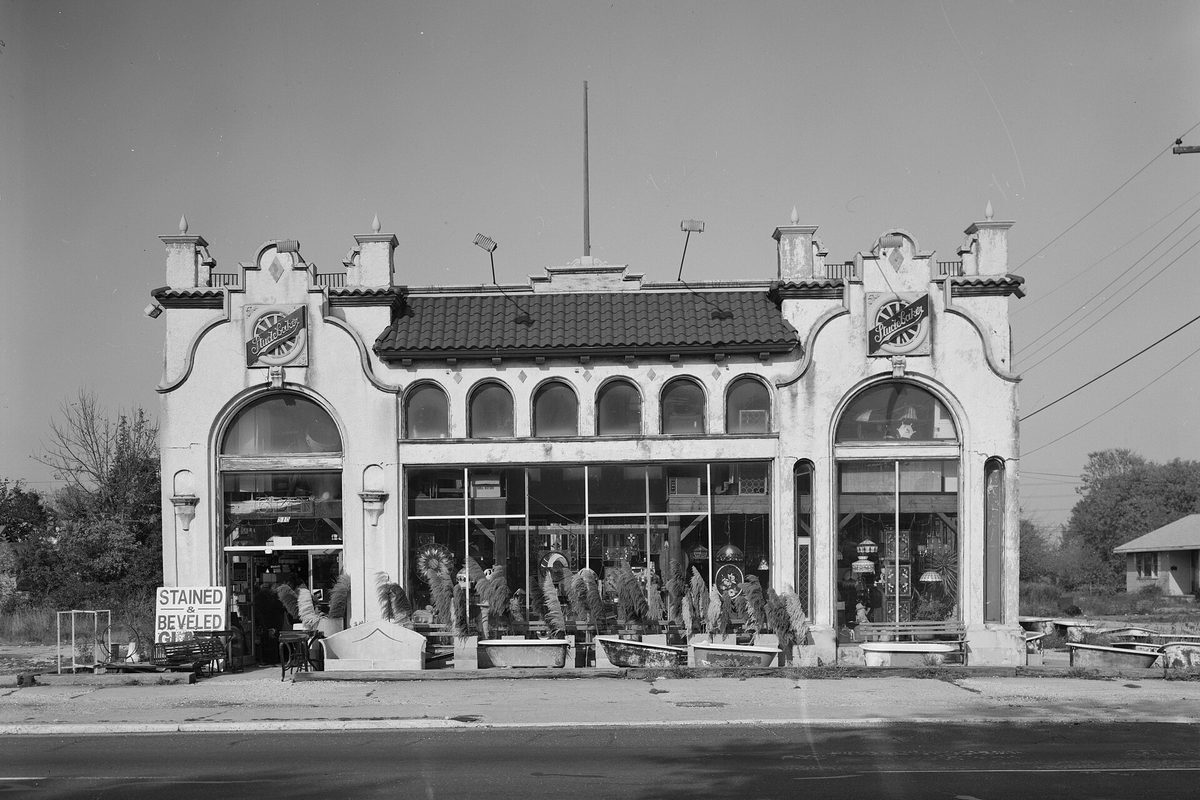 Black-and-white survey photo of the former Studebaker dealership on the Black Horse Pike in Pleasantville, a stucco building with a tile roof and tall arched windows