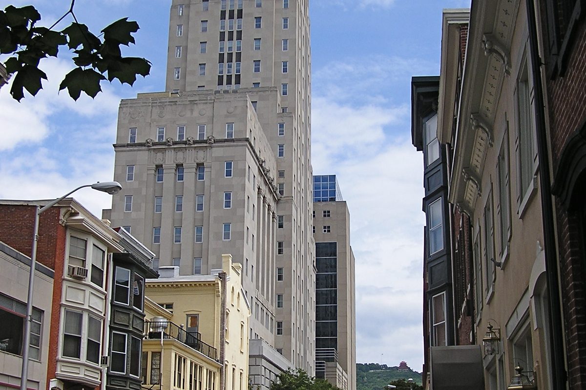 Downtown Reading, with the tall cream-colored Berks County Courthouse tower rising behind older row buildings and a street lamp