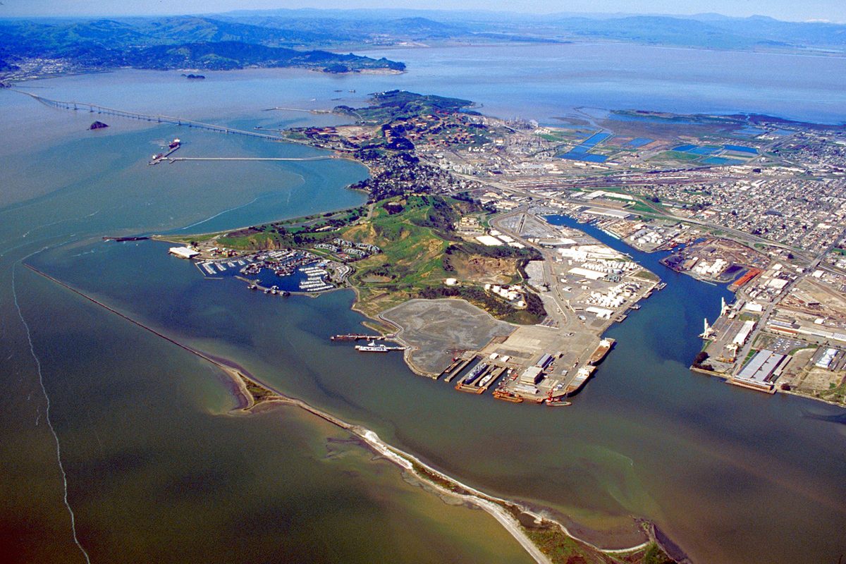 Aerial view of Richmond's shoreline, port and marina on San Francisco Bay, with the Richmond-San Rafael Bridge and the Marin hills beyond