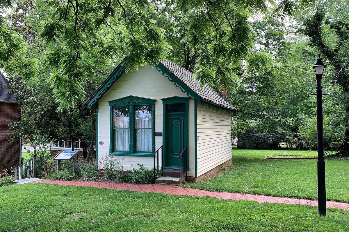 The small white wooden office of Dr. Edward Stonestreet, built around 1852, with green trim and a brick path, on the lawn of the Beall-Dawson House in Rockville