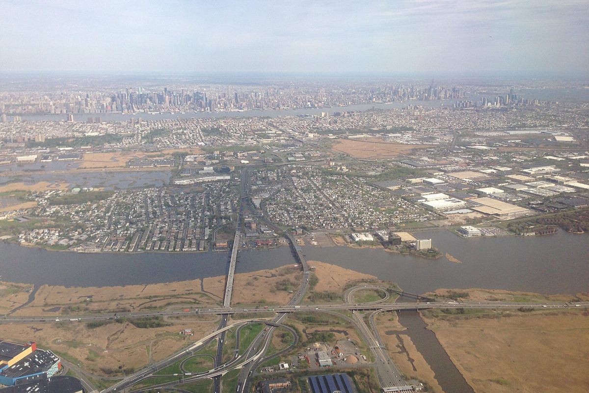 Aerial view of Secaucus with the Hackensack River, the New Jersey Turnpike and Route 3 interchanges in front and the Manhattan skyline on the horizon