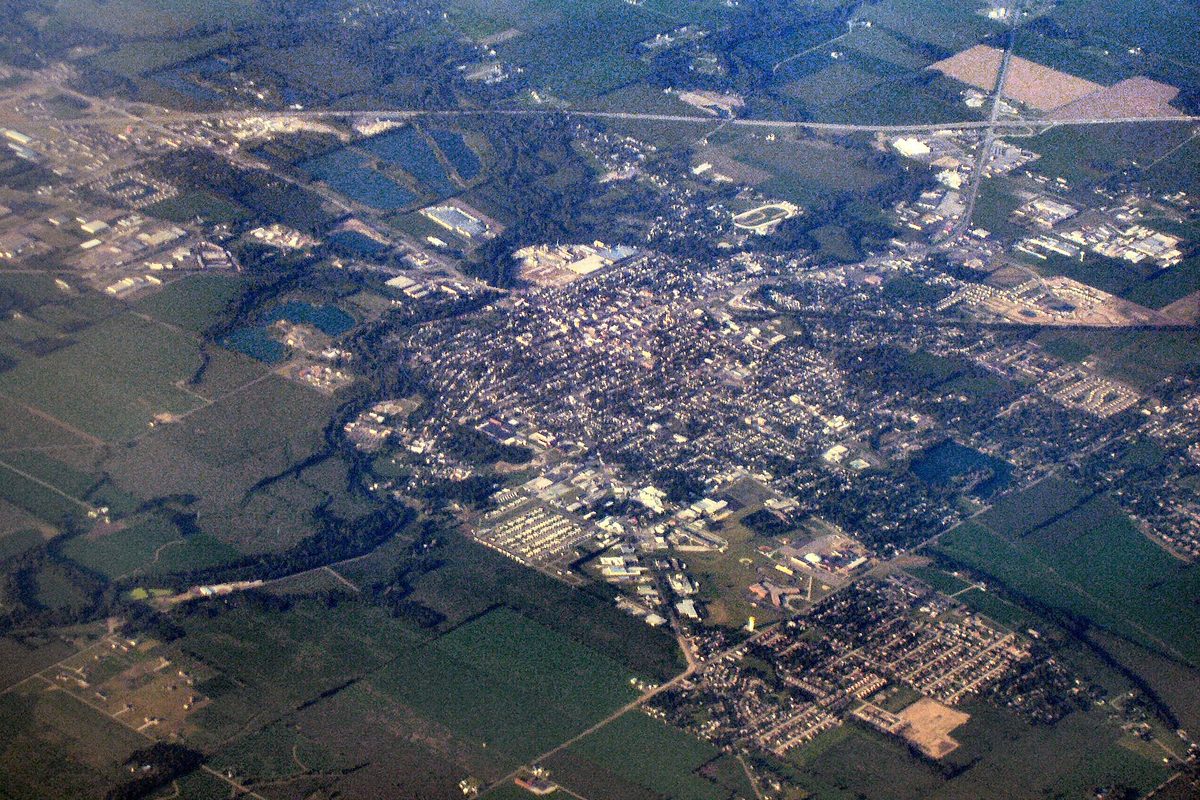 Aerial view of Shelbyville, Indiana, its grid of streets and buildings surrounded by farm fields and ponds