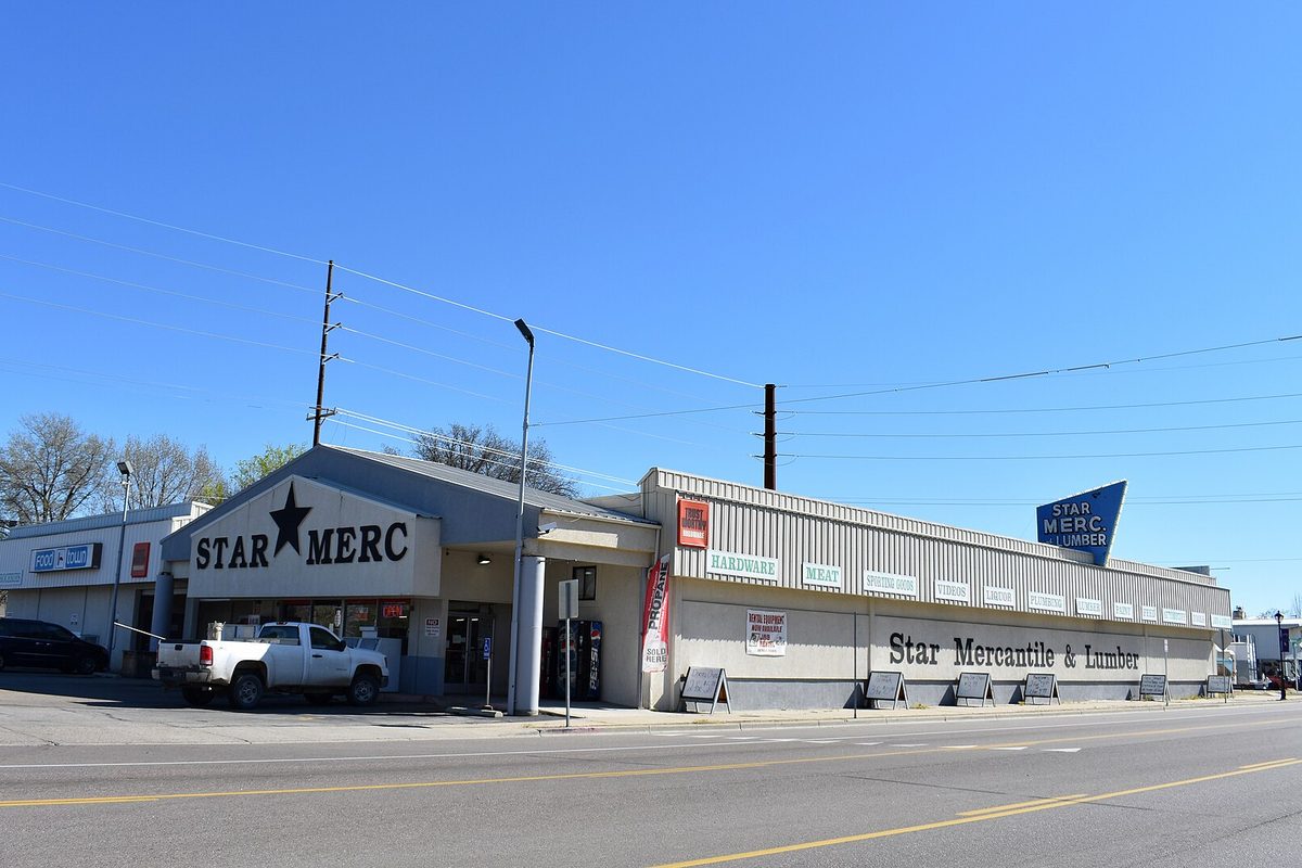 The Star Mercantile and Lumber store front in Star, with a white pickup parked outside under a clear blue sky