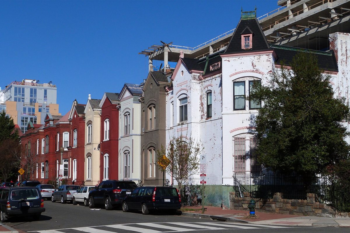 Rowhouses on Wallach Place NW in the Greater U Street area of Washington, DC, with cars parked along the curb