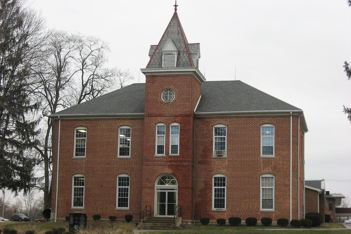 The red-brick former Union High Academy in Westfield, with a slate cupola above its arched front door, under a gray winter sky