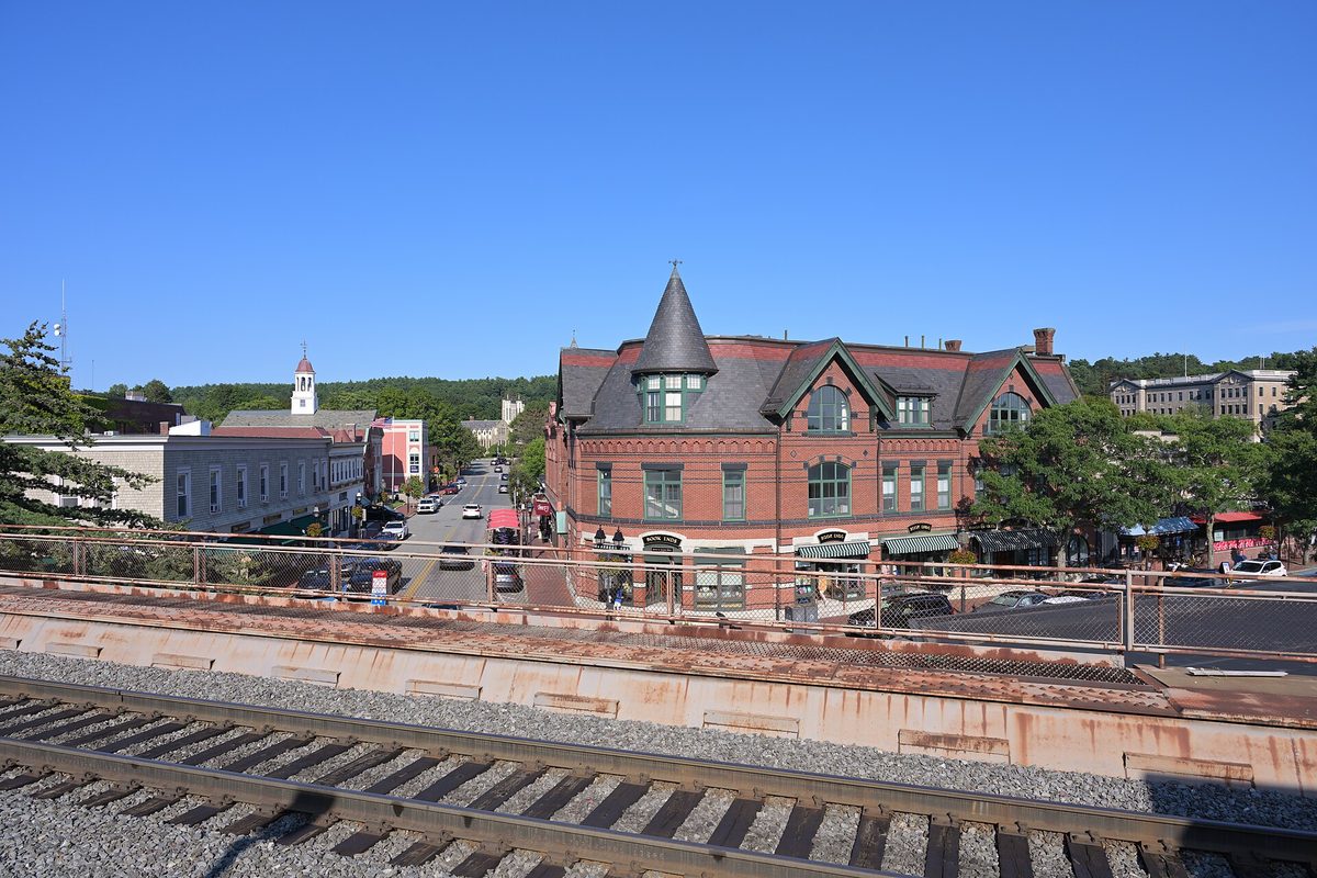 Winchester Center seen from the train platform, with a red-brick building topped by a turret and Main Street running into the distance
